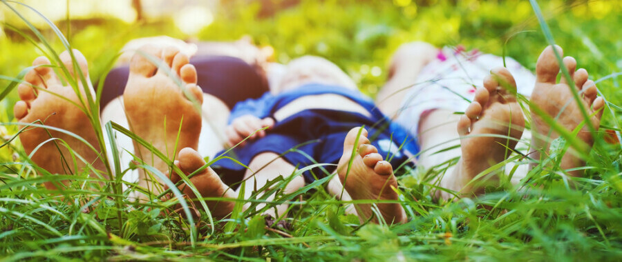 Healthy family's feet in the grass