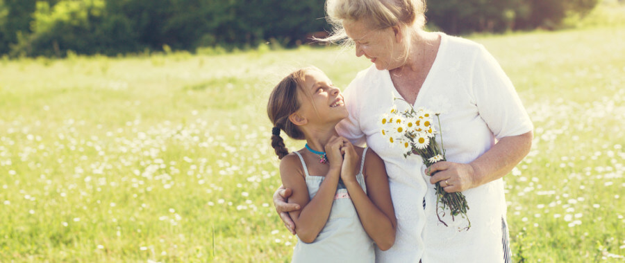 Grandparent hugging granddaughter with flowers after getting functional medicine treatment for menopause