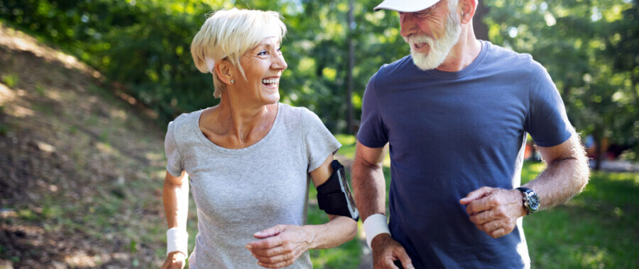 Older couple running outdoors to help hormone imbalance