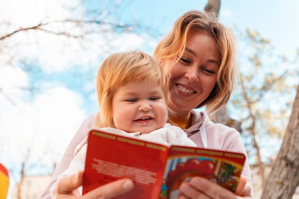 Mother reads to young child with autism who has been helped with MeRT therapy