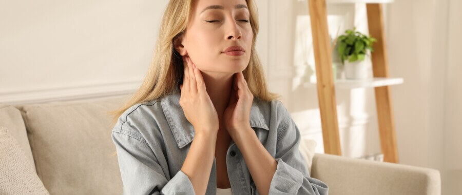 woman doing thyroid self examination
