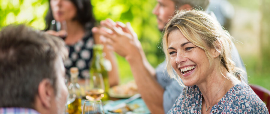 woman smiling at dinner table